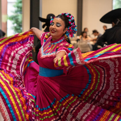 Girl wearing pink dress twirling