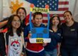A group of CPP students and employees pose with props