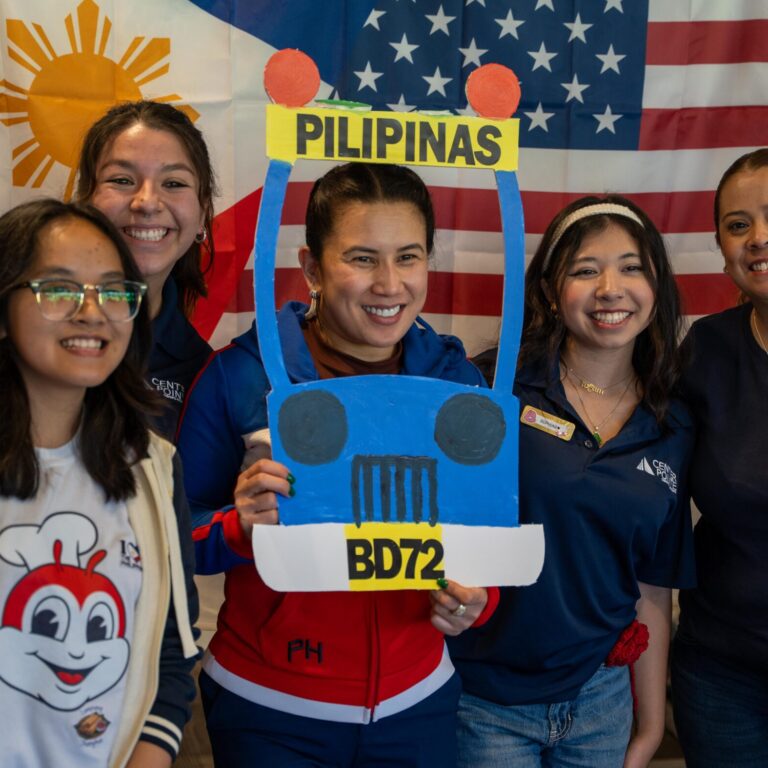 A group of CPP students and employees pose with props